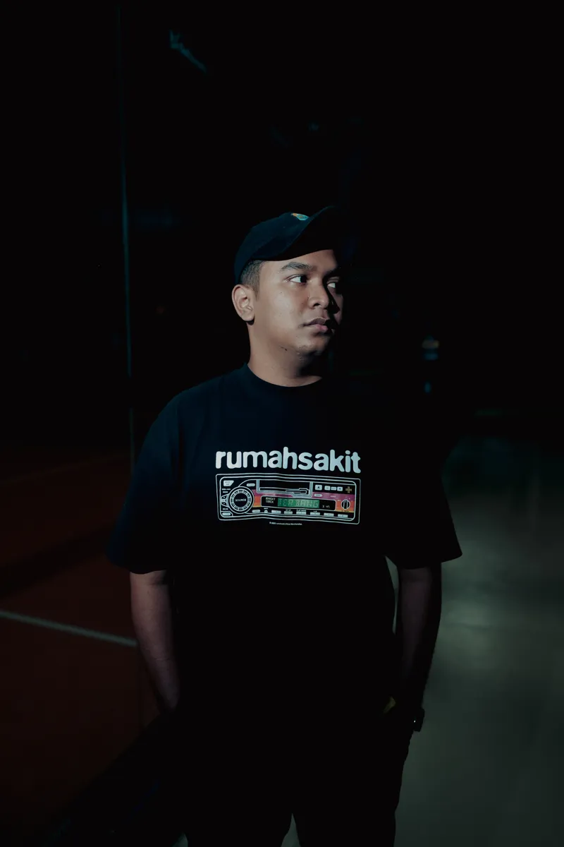 Ikhwan Tricahya in a dark studio, wearing a black cap
