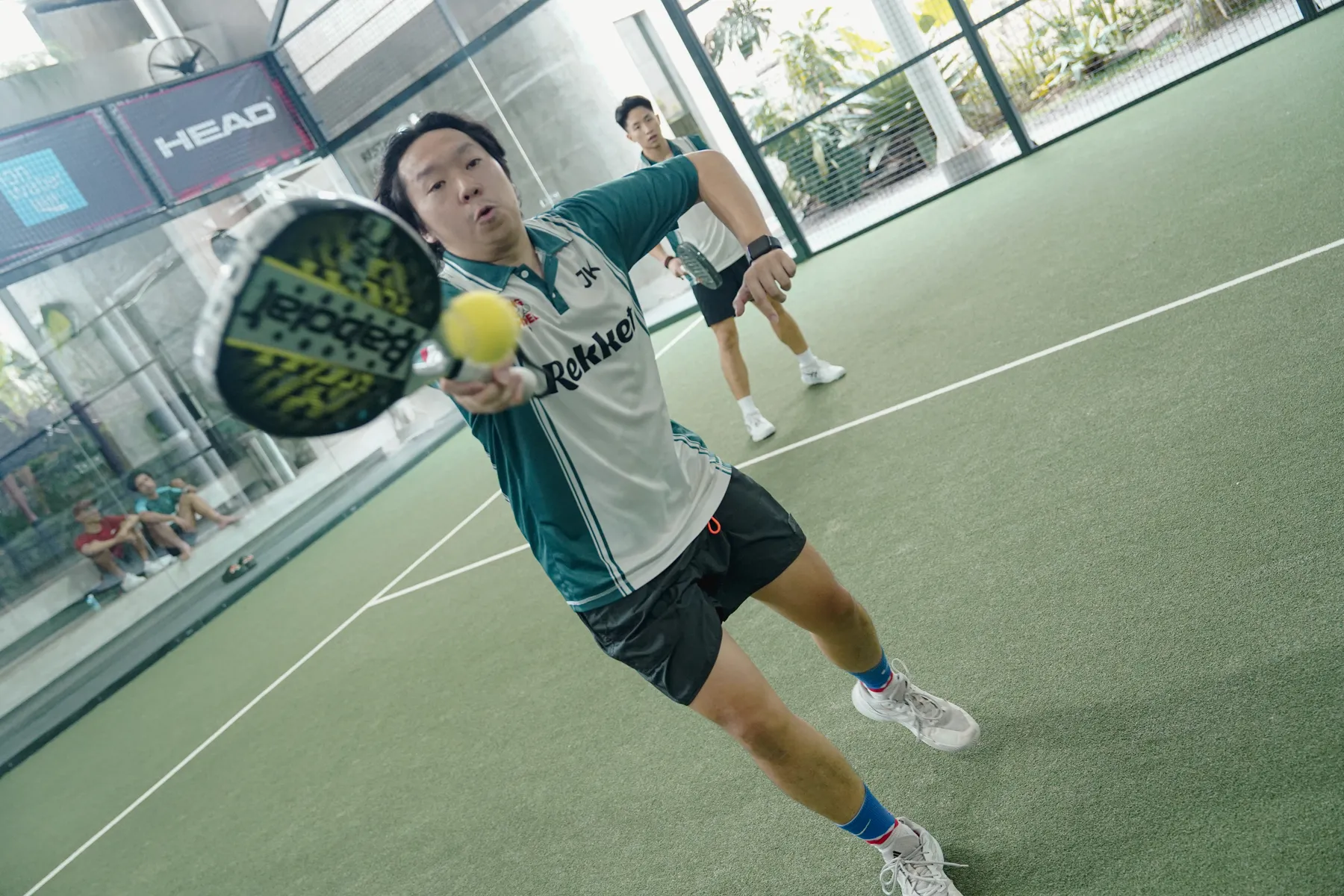 Player lunging for a low ball on court