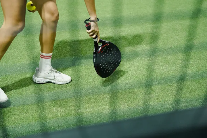 Close-up of a player's footwork and paddle