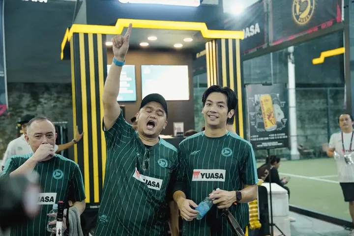 Team celebrating in front of the sponsor booth
