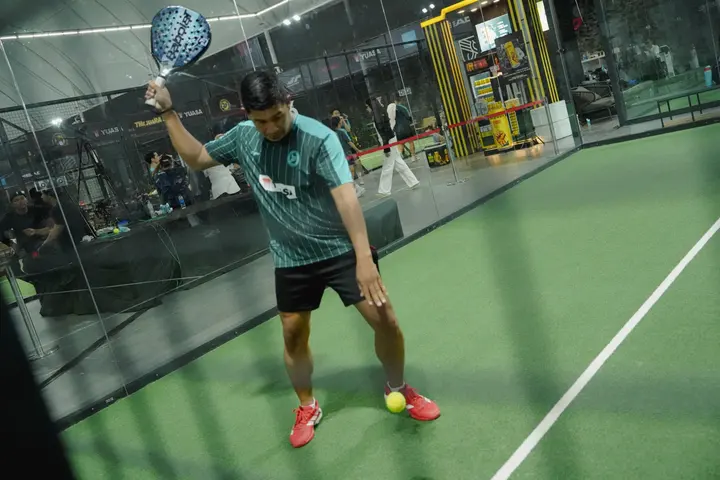 Player reaching for a ball near the baseline